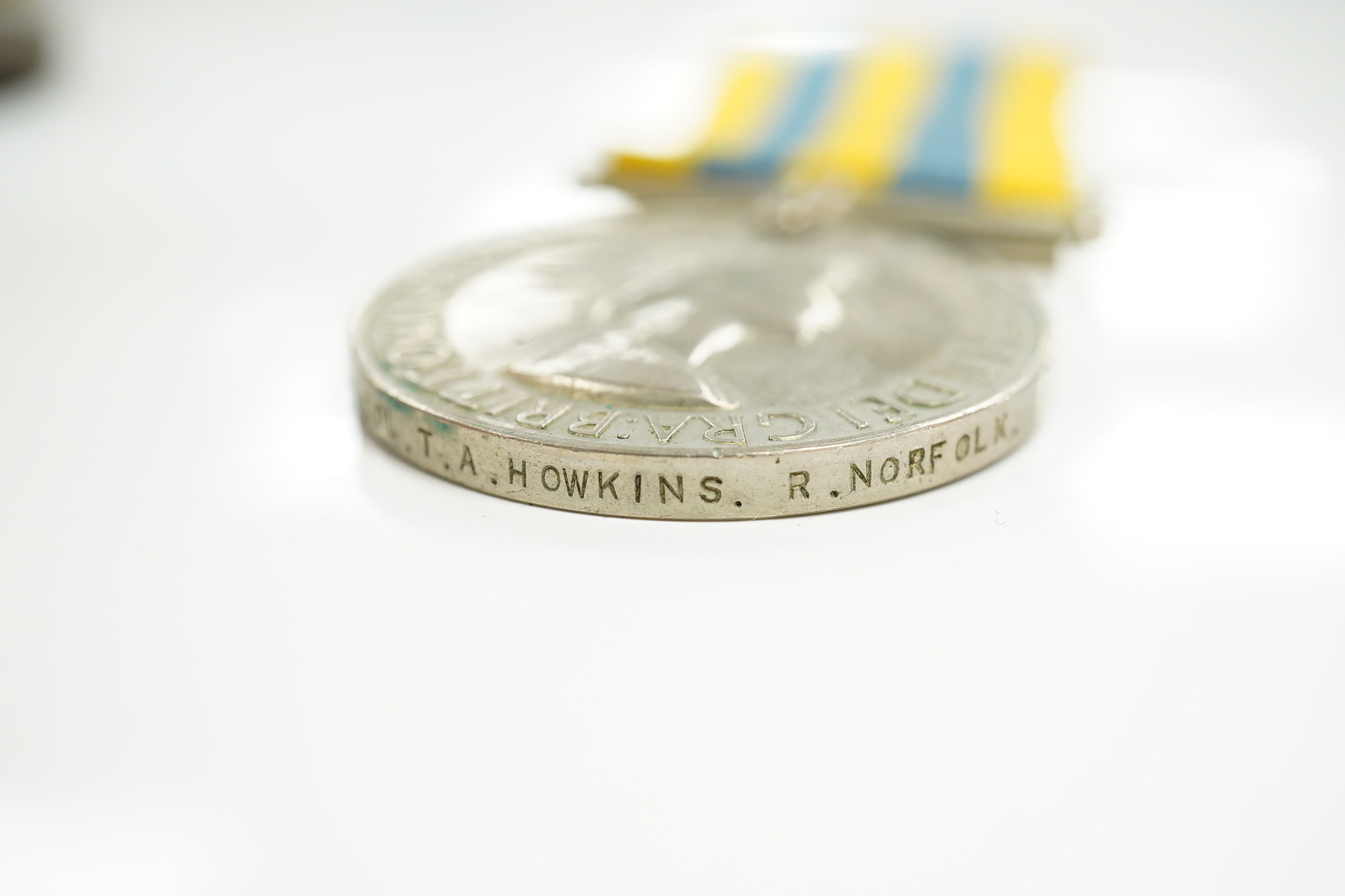 A First World War medal pair awarded to SJT. F.C. Howkins, The Queen’s R., together with a QEII Korea medal pair awarded to CPL. T.A. Howkins, R. Norfolk, plus a Lusitania propaganda medallion, all contained in a Princes